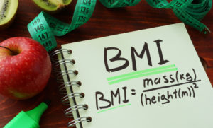 BMI body mass index written on a notepad sheet.